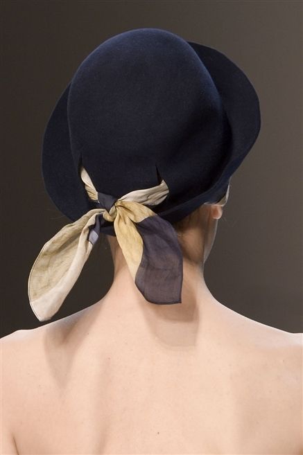 Costume accessory, Headgear, Neck, Back, Tan, Barechested, Costume hat, Ribbon, Natural material, Knot, 