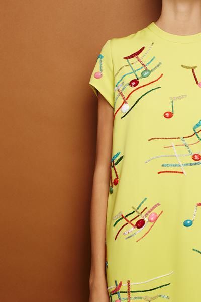 Yellow, Sleeve, Shoulder, Joint, Pattern, Peach, Active shirt, Visual arts, Pattern, Button, 