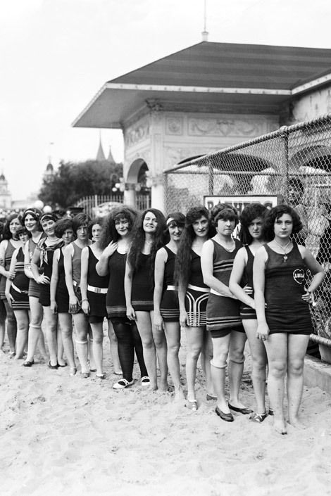 Social group, Photograph, Standing, Swimwear, Wire fencing, Active shorts, Chain-link fencing, Bermuda shorts, Trunks, Crew, 