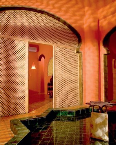 Interior design, Ceiling, Wall, Amber, Floor, Arch, Orange, Tile, Light fixture, Hall, 