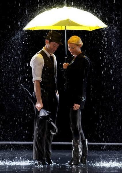 Human body, Umbrella, Standing, Water feature, Jacket, Street fashion, Fountain, Rain, Snapshot, Precipitation, 