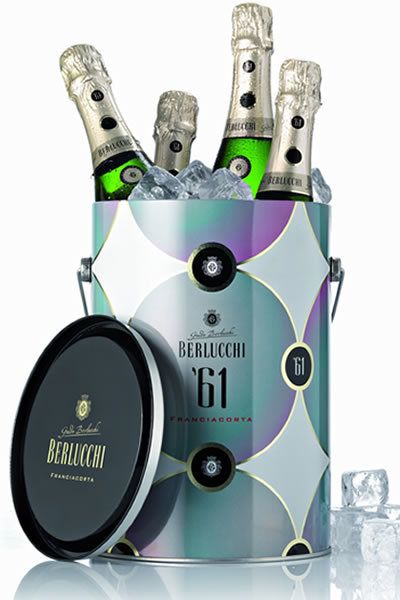 Bottle, Audio equipment, Logo, Glass bottle, Alcohol, Alcoholic beverage, Circle, Audio accessory, Trademark, Silver, 