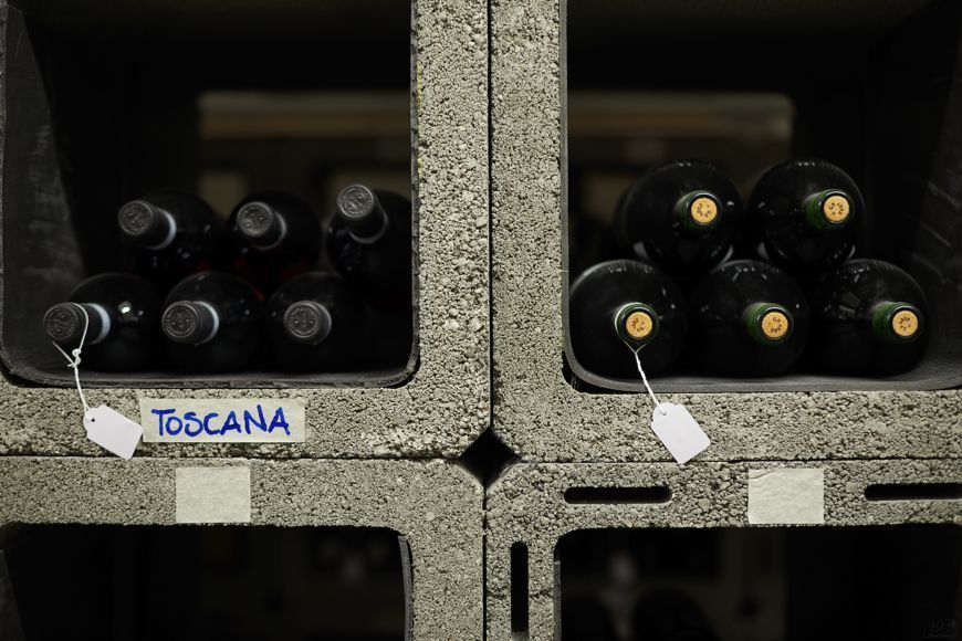 Wine rack, Bottle, Bottle cap, Symmetry, Still life photography, Wine cellar, Winery, Wine bottle, Glass bottle, 