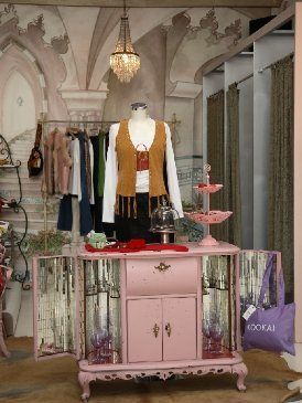 Light fixture, Cabinetry, Collection, Mannequin, Clothes hanger, Chandelier, Drawer, Fashion design, Boutique, Sideboard, 