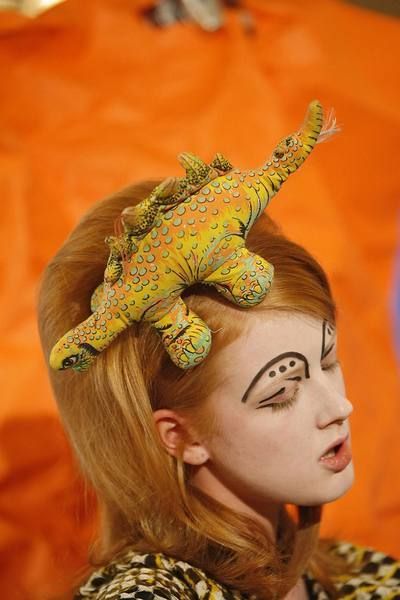 Adaptation, Hair accessory, Headgear, Orange, Scaled reptile, Headpiece, Makeover, Claw, Tradition, Lizard, 