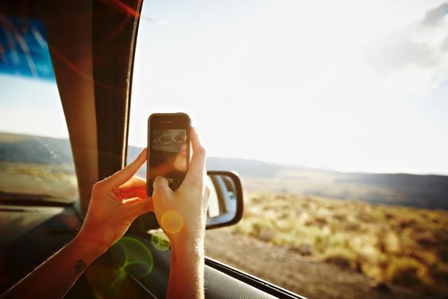 Finger, Glass, Sunlight, Travel, Automotive mirror, Mobile phone, Nail, Road trip, Communication Device, Portable communications device, 