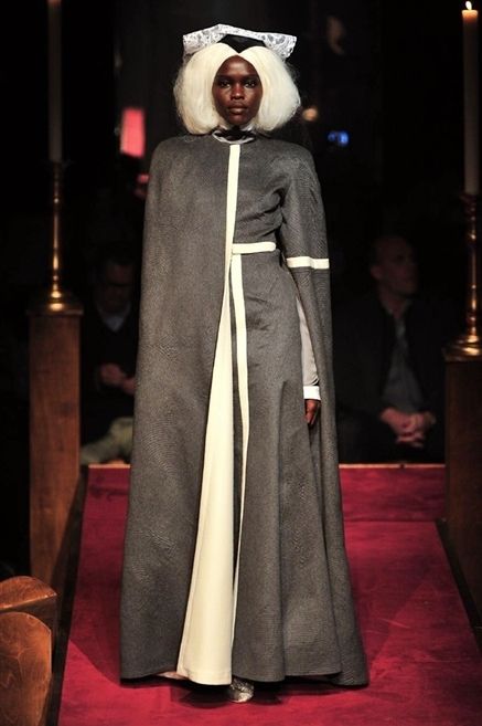 Standing, Cloak, Costume design, Costume, Costume accessory, Fictional character, Cape, Carpet, Mantle, Acting, 
