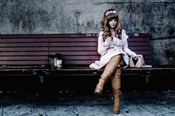 Sitting, Fashion accessory, Boot, Bench, Street fashion, Knee, Headpiece, Leather, Natural material, Fur, 