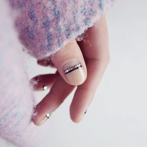 <p>Nail Artist&nbsp;Frédérique Olthuis gave her negative nail a subtle shine. To get the look, paint a clear base coat and let dry. Add a thin,&nbsp;black stripe at the half moon. When tacky, add metallic flat sequins to the strip and seal it with a clear top coat.&nbsp;</p><p><em data-redactor-tag="em" data-verified="redactor">Design by&nbsp;<span class="redactor-invisible-space" data-verified="redactor" data-redactor-tag="span" data-redactor-class="redactor-invisible-space"></span></em><a href="https://www.instagram.com/p/BLyS3Ozg4Gk/" target="_blank"><em data-redactor-tag="em" data-verified="redactor">@trnailart</em></a></p>