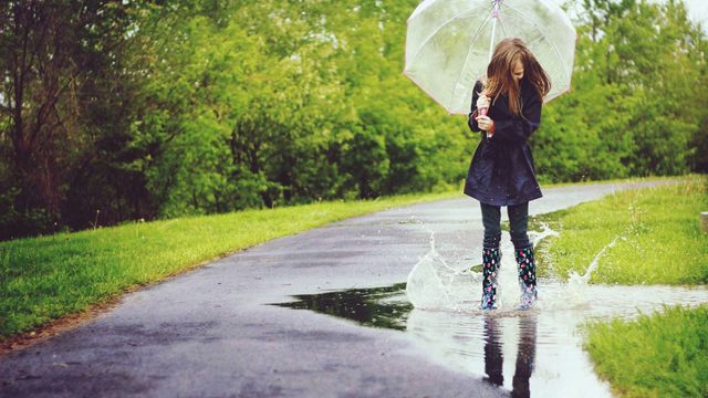 Clothing, Human, Green, Road surface, Outerwear, People in nature, Asphalt, Boot, Street fashion, Umbrella, 