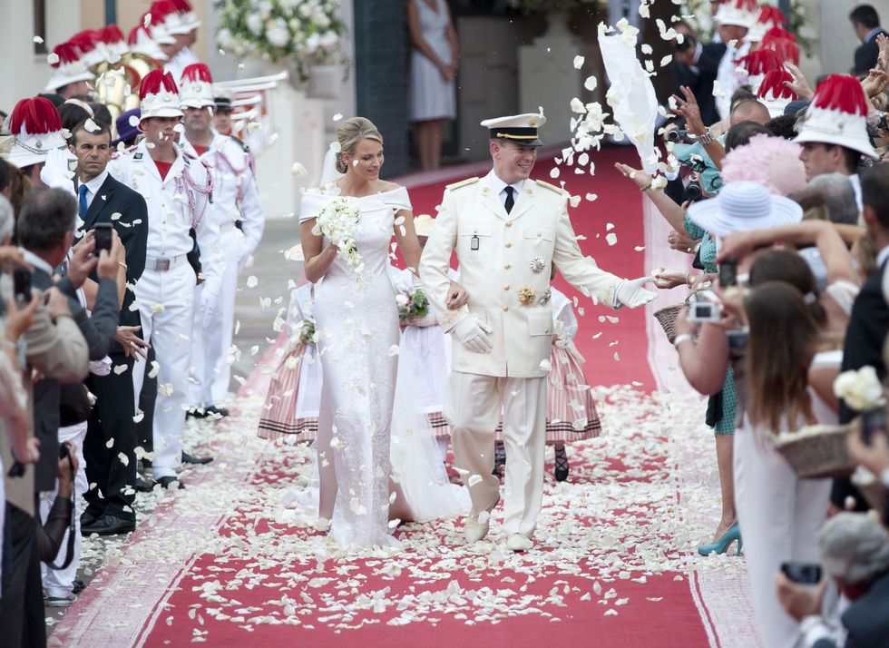Event, Hat, Petal, Tradition, Carpet, Ceremony, Headgear, Marriage, Sun hat, Bridal clothing, 