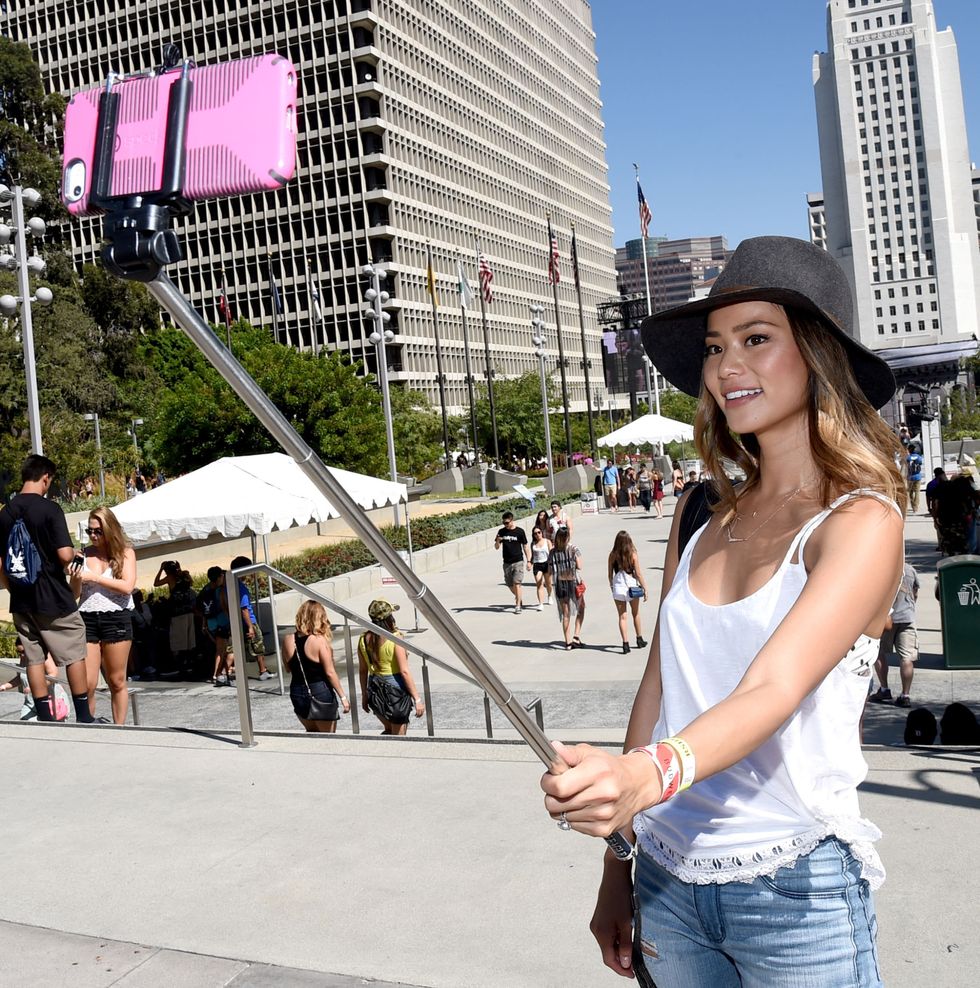 LOS ANGELES, CA - AUGUST 30:  Actress Jamie Chung, wearing American Eagle Sky High Demin, takes a selfie at American Eagle Outfitters Celebrates the Budweiser Made in America Music Festival during day 1 at Los Angeles Grand Park on August 30, 2014 in Los Angeles, California.  (Photo by Michael Buckner/Getty Images for American Eagle)
