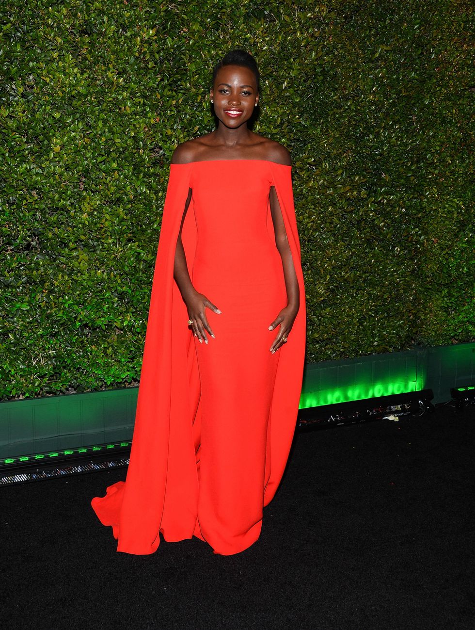 <p>Lupita is a big fan of all brightly colored dresses, but this electric red Ralph Lauren gown is really something special. </p>