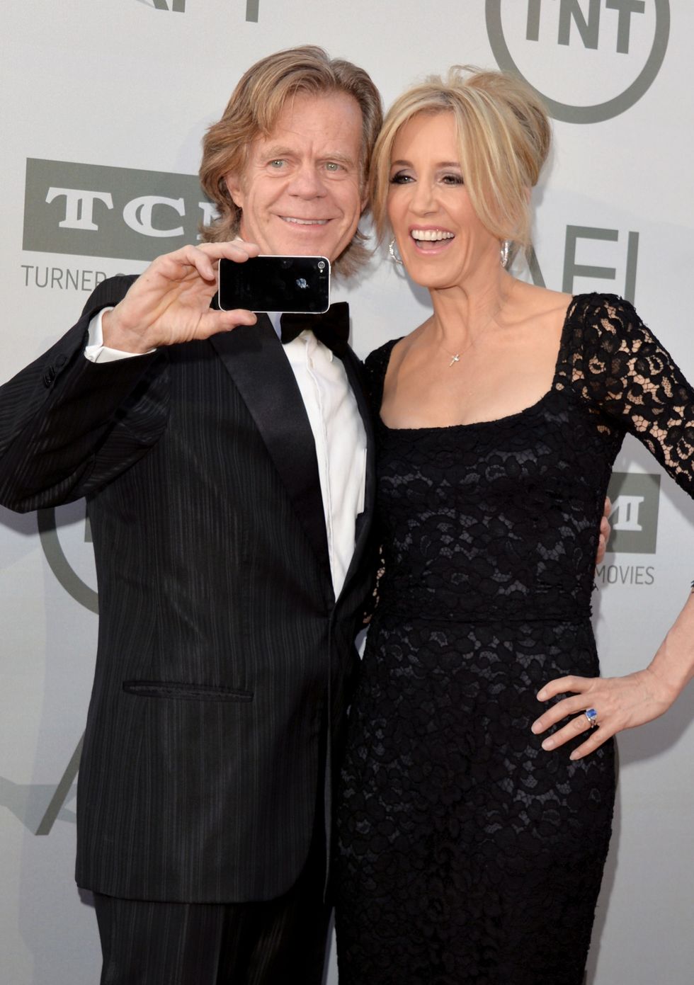 HOLLYWOOD, CA - JUNE 05:  Actors William H. Macy (L) and Felicity Huffman take a selfie photo at the 2014 AFI Life Achievement Award: A Tribute to Jane Fonda at the Dolby Theatre on June 5, 2014 in Hollywood, California. Tribute show airing Saturday, June 14, 2014 at 9pm ET/PT on TNT.  (Photo by Lester Cohen/WireImage)