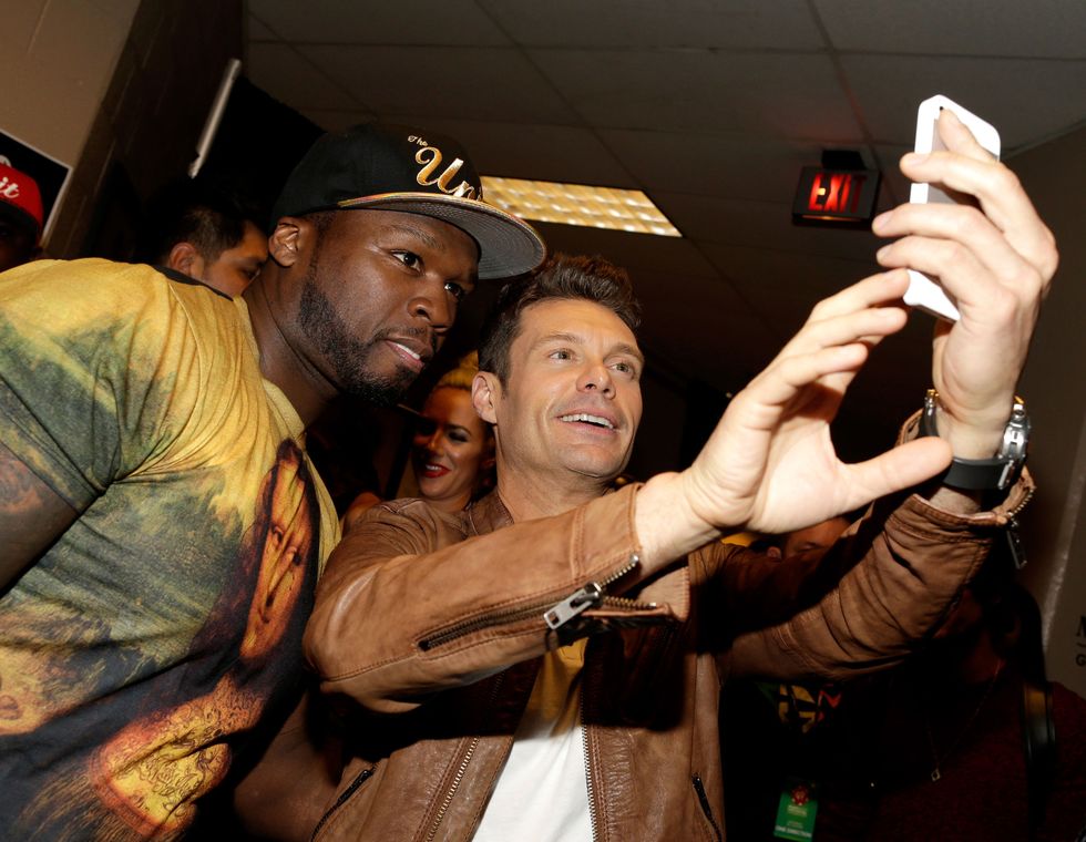 LAS VEGAS, NV - SEPTEMBER 20:  Recording artist Curtis '50 Cent' Jackson (L) and host Ryan Seacrest pose for a selfie photo during the 2014 iHeartRadio Music Festival at the MGM Grand Garden Arena on September 20, 2014 in Las Vegas, Nevada.  (Photo by Isaac Brekken/Getty Images for Clear Channel)