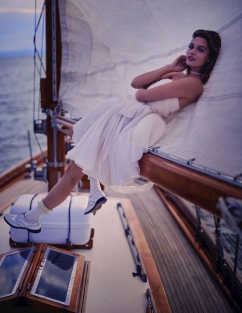 Dress, Elbow, Boat, Watercraft, Naval architecture, Bridal clothing, Model, Deck, Fashion model, Long hair, 