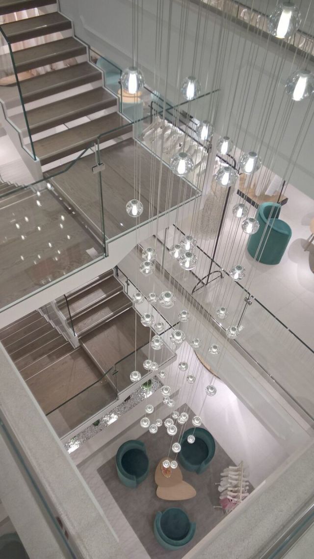 Urban design, Stairs, Light fixture, Transparent material, Silver, Ceiling fixture, Cylinder, 