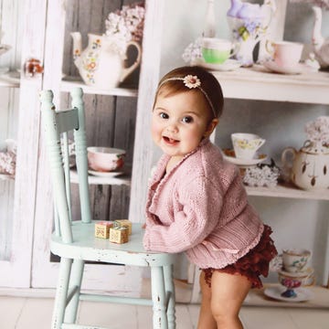 Child, Pink, Toddler, Dress, Room, Furniture, Toy, Sitting, Interior design, Table, 