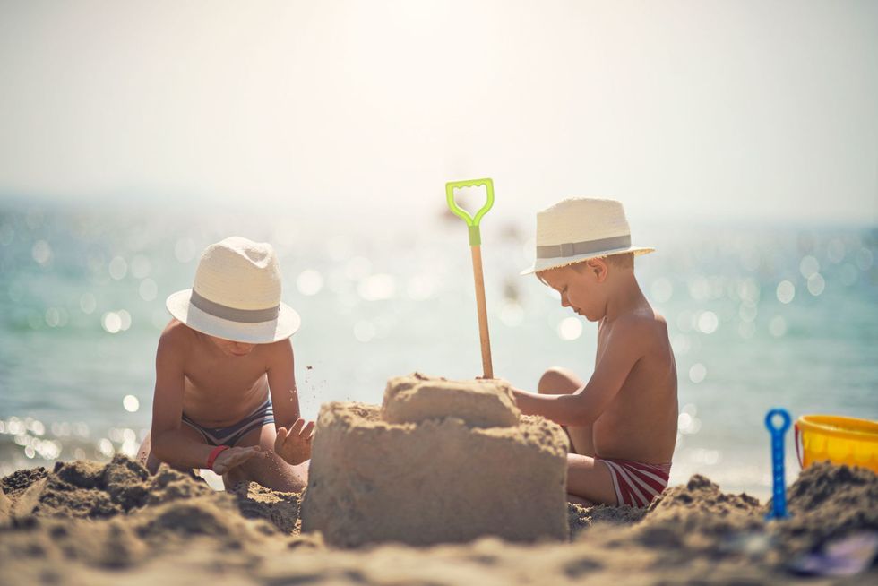 Hat, Fun, Human body, Sand, Sitting, Leisure, People on beach, People in nature, Summer, Sun hat, 