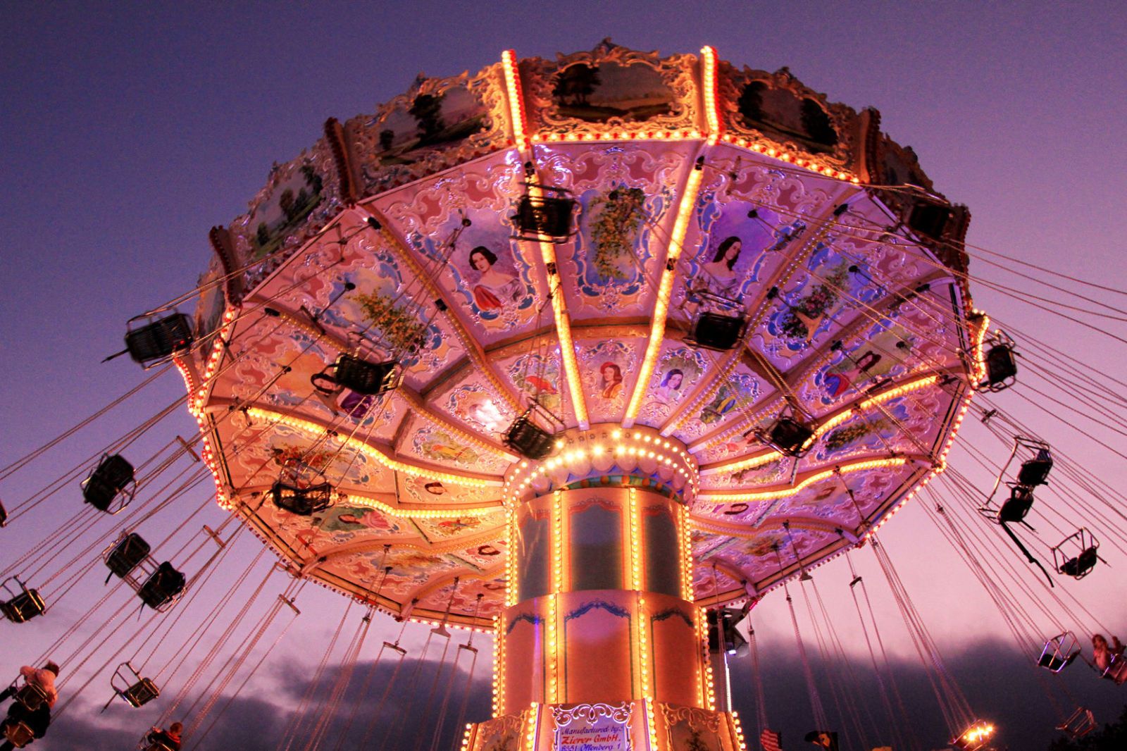 Amusement ride, Amusement park, Landmark, Fair, Fun, Light, Night, Purple, Tourist attraction, Carousel, 
