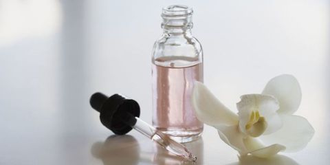 Perfume, Glass bottle, Bottle, Product, Petal, Still life photography, Glass, Flower, Liquid, Cosmetics, 