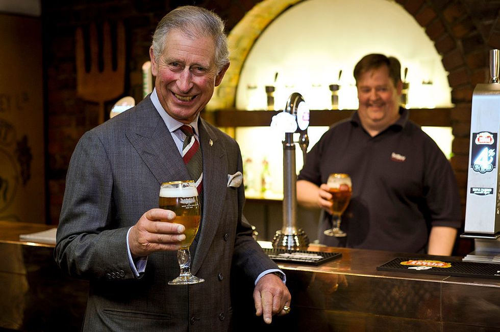 Prince Charles drinking a pint of beer
