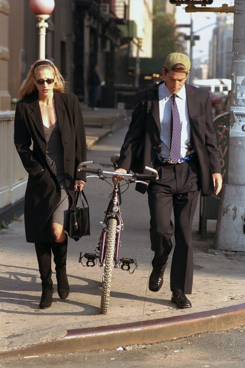 <p>Arguably the most famous slip-dress advocate of the era, Besette-Kennedy strolls through downtown NYC with her husband, 1996. </p>