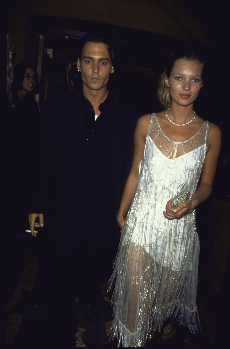 <p>With then-beau Johnny Depp, the supermodel sparkles in a silk slip by Calvin Klein. Embellished with sequins, this flapper dress was once worn by Mrs. Errol Flynn, 1994.</p>