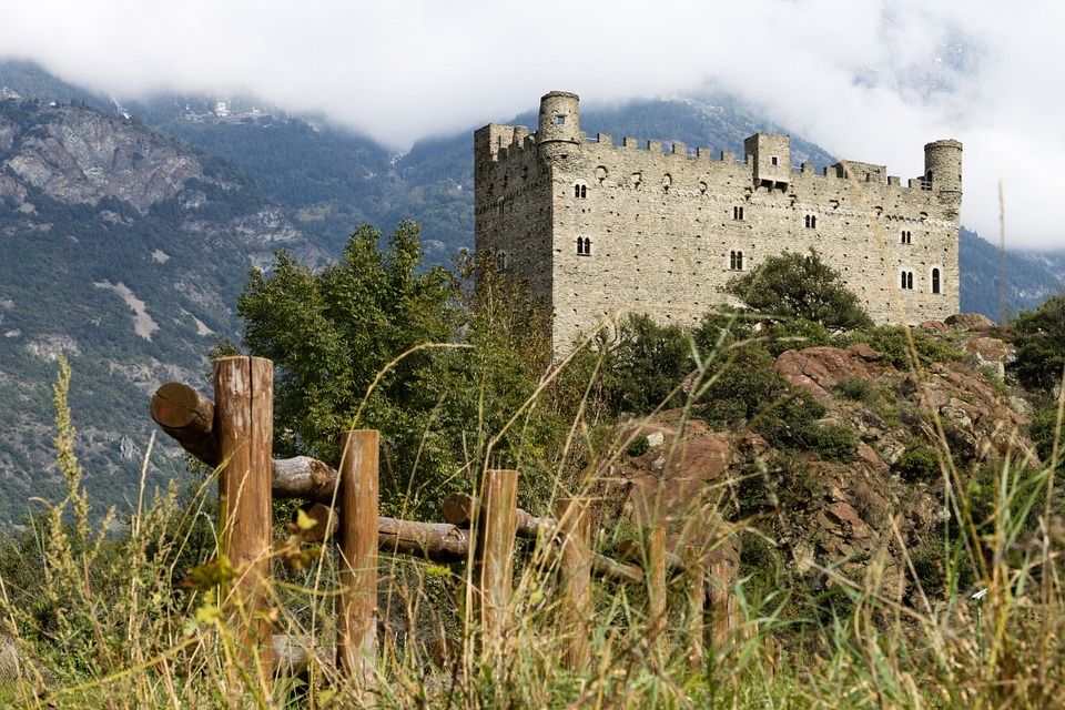 Castle, Natural landscape, Château, Ruins, Highland, Grass family, Fortification, Grass, Building, Mountain, 