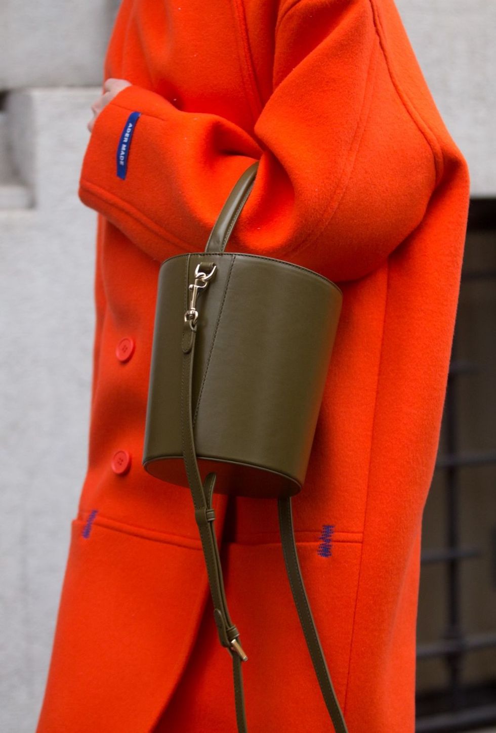 Orange, Red, Bag, Handbag, Outerwear, Personal protective equipment, Fashion accessory, Leather, Jacket, Street fashion, 
