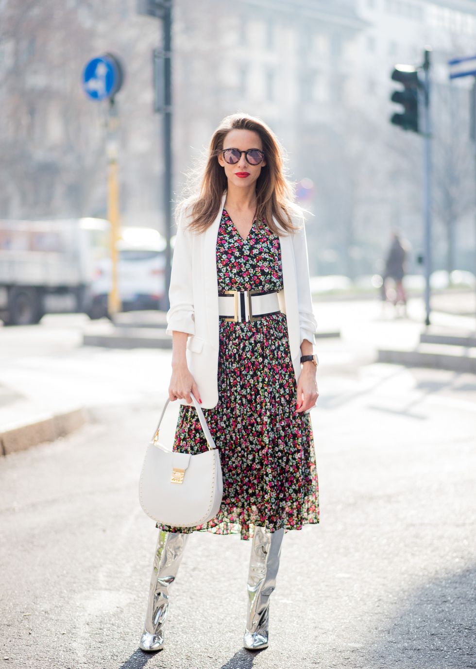 MILAN, ITALY - FEBRUARY 21: Alexandra Lapp wearing a long flower dress from H&amp;M, silver shiny boots by H&amp;M, a long white blazer from Zara, a lacquer waist belt in white and black from Balmain, a white Patricia Hobo bag with studs and sunglasses from Le Specs in pink seen during Milan Fashion Week Fall/Winter 2018/19 on February 21, 2018 in Milan, Italy. (Photo by Christian Vierig/Getty Images)