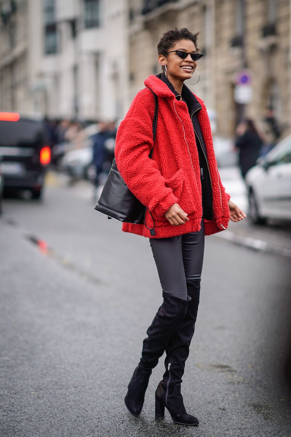 PARIS, FRANCE - MARCH 01:  A model wears a red coat, black thigh high boots, during Paris Fashion Week Womenswear Fall/Winter 2018/2019, on March 1, 2018 in Paris, France.  (Photo by Edward Berthelot/Getty Images)