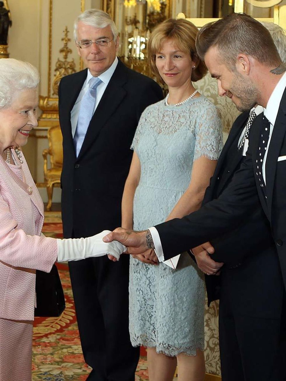 Queen Elizabeth II meets David Beckham at a reception at Buckingham Palace to celebrate The Queen's Young Leaders programme and present awards to the first successful winners of the Commonwealth project, June 2015.