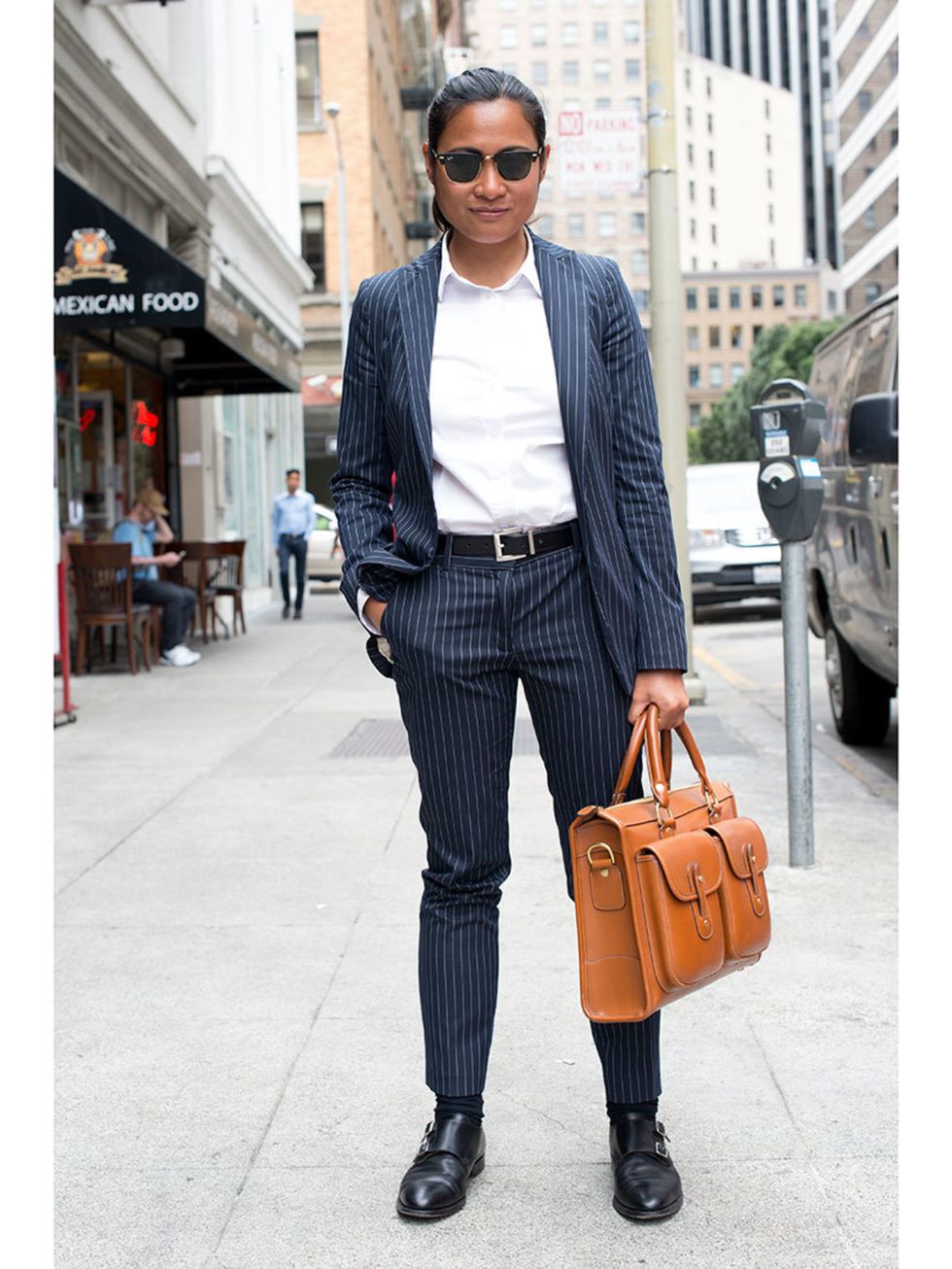 Cris Domingo wears Zara suit, Rolex watch, Ghurka bag, Brooks Brothers shoes, Rayban sunglasses and Target belt.