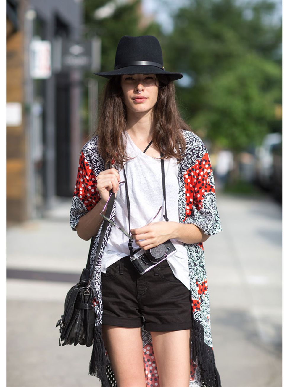 <p>Carly Foulkes wears Rag and Bone hat and T-shirt, ASOS kimono, Joe's jeans shorts and Frye purse.</p>