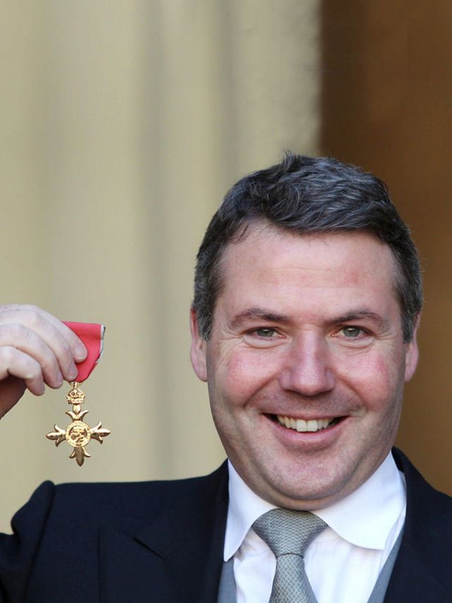 <p>Nick Robertson collecting his OBE</p>
