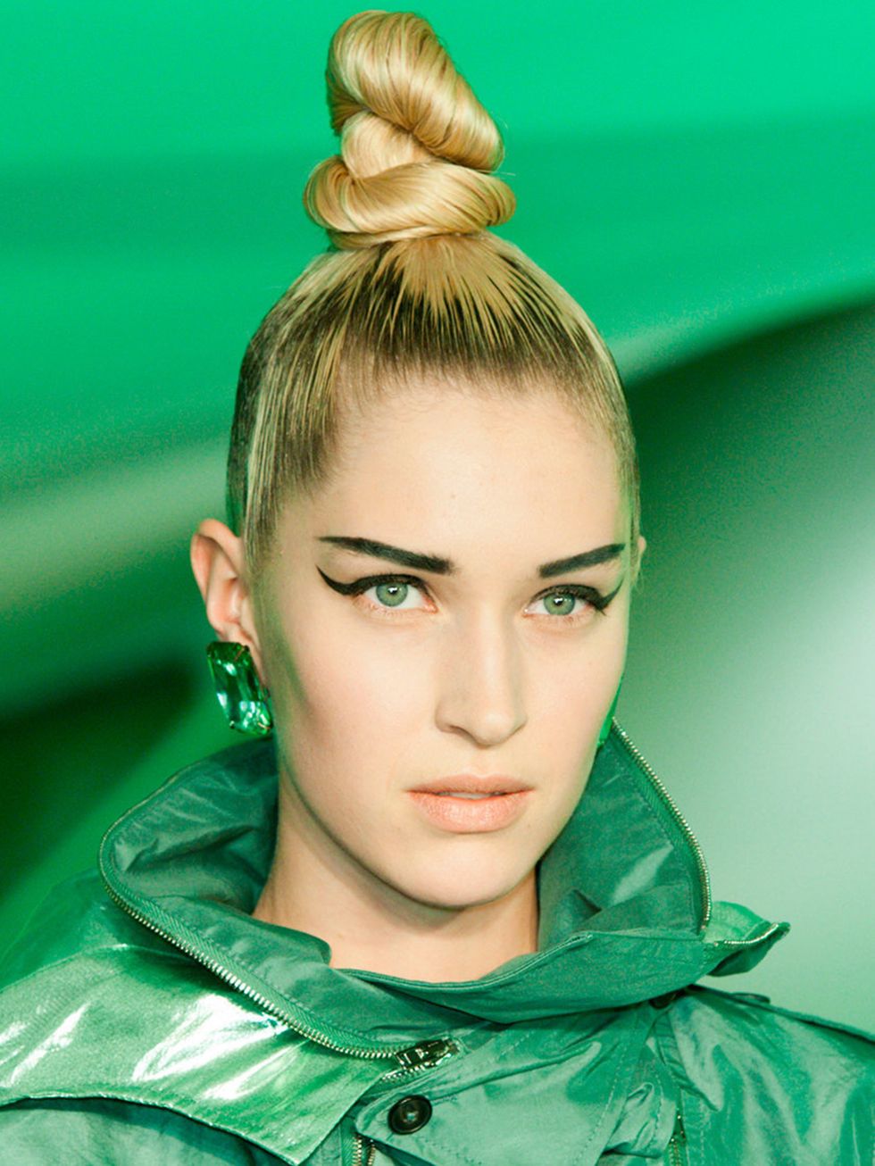<p>Hair Stylist: Guido for Redken</p><p>Look: Severe topknots</p><p>Inspiration: Futuristic Britain</p><p>Key Product: Redken Hardware 16 Gel</p><p>Tip: Use gel on through your hair to slick back the hair into a sleek twisted topknot.</p>
