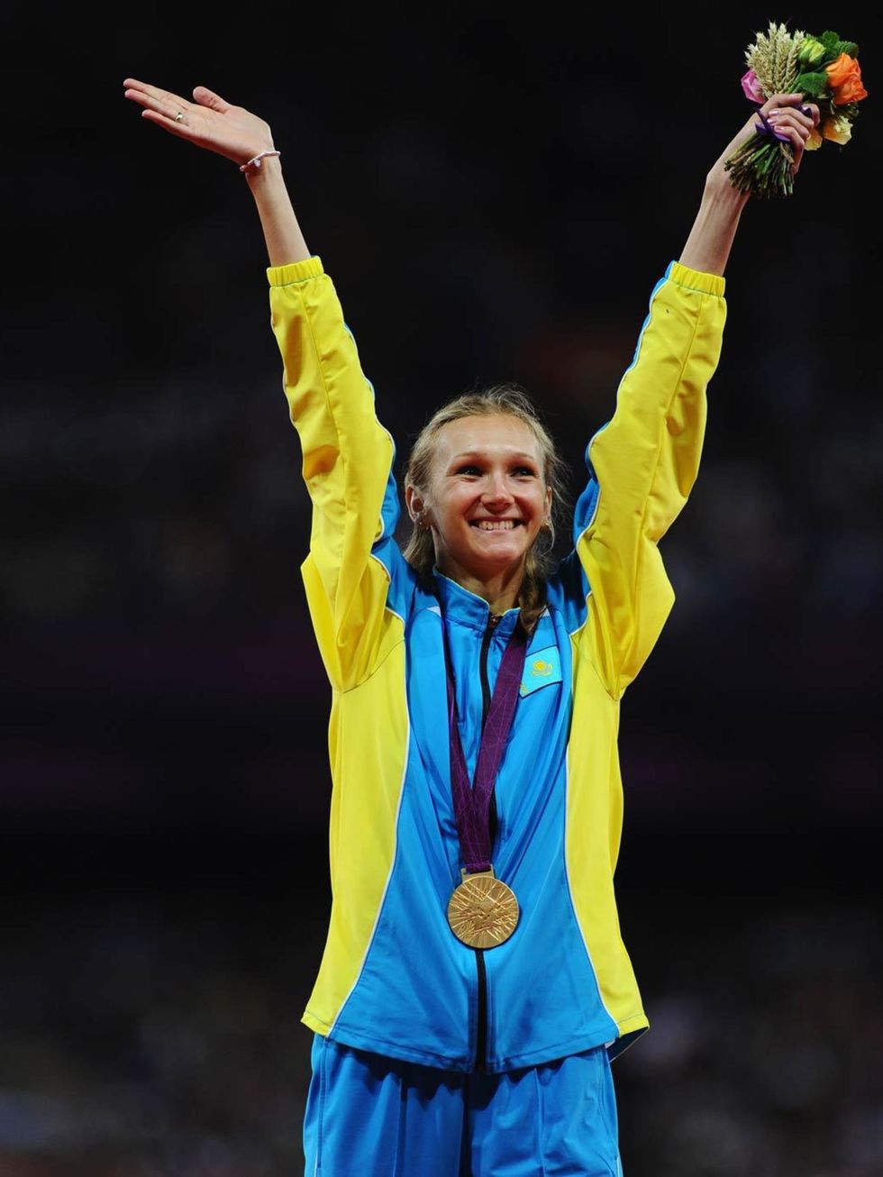 <p>Olga Rypakova poses on the podium with her gold medal for the Women's Triple Jump final at the London Olympics, August 2012.</p>