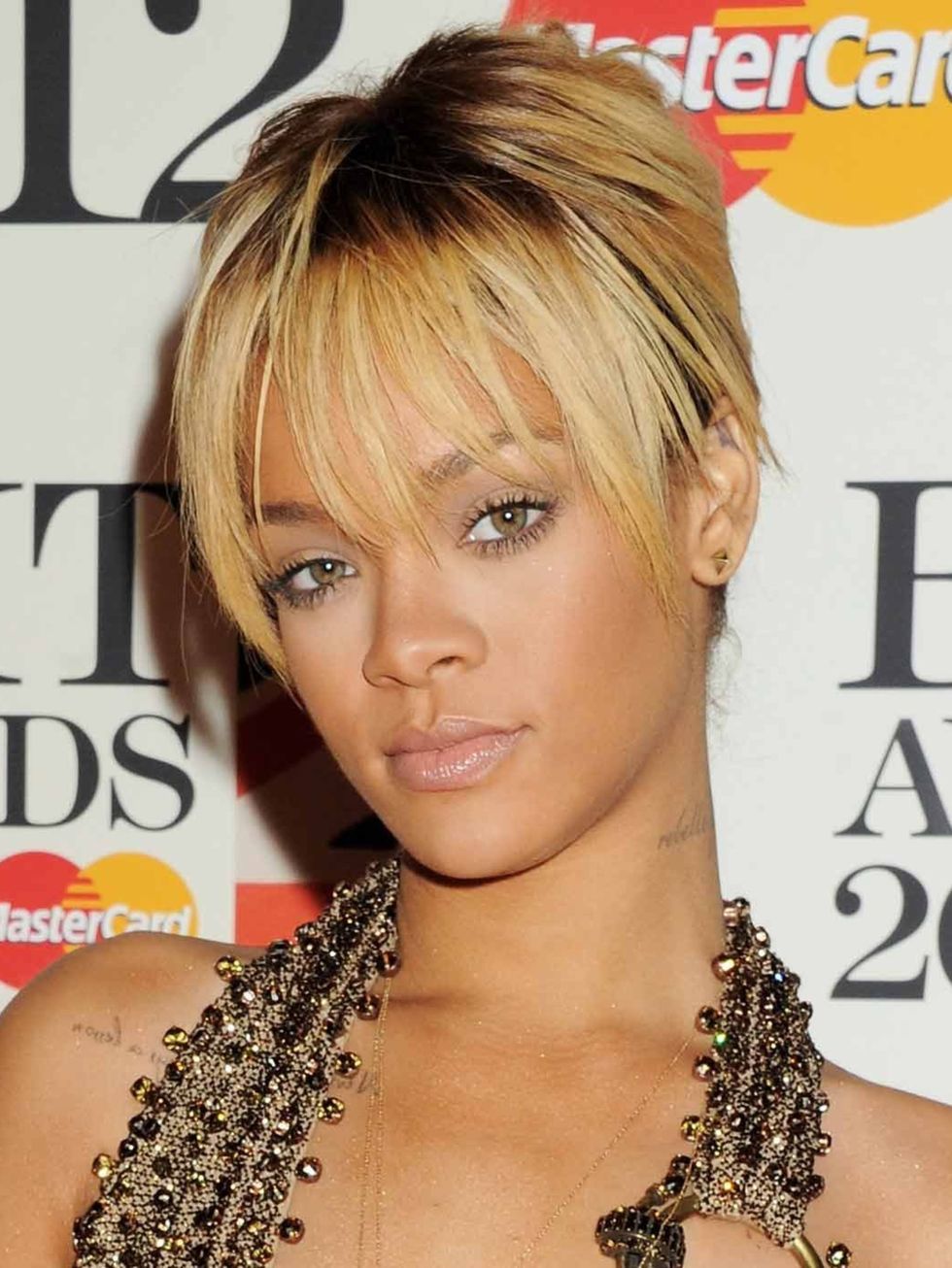 <p>Rihanna wears her hair in a simple chignon. </p>