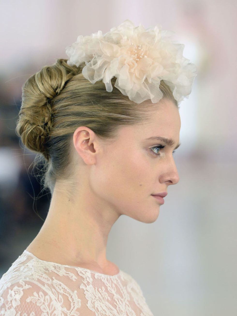 Oscar De La Renta brought back the French twist and made it modern with an exaggerated tulle fascinator