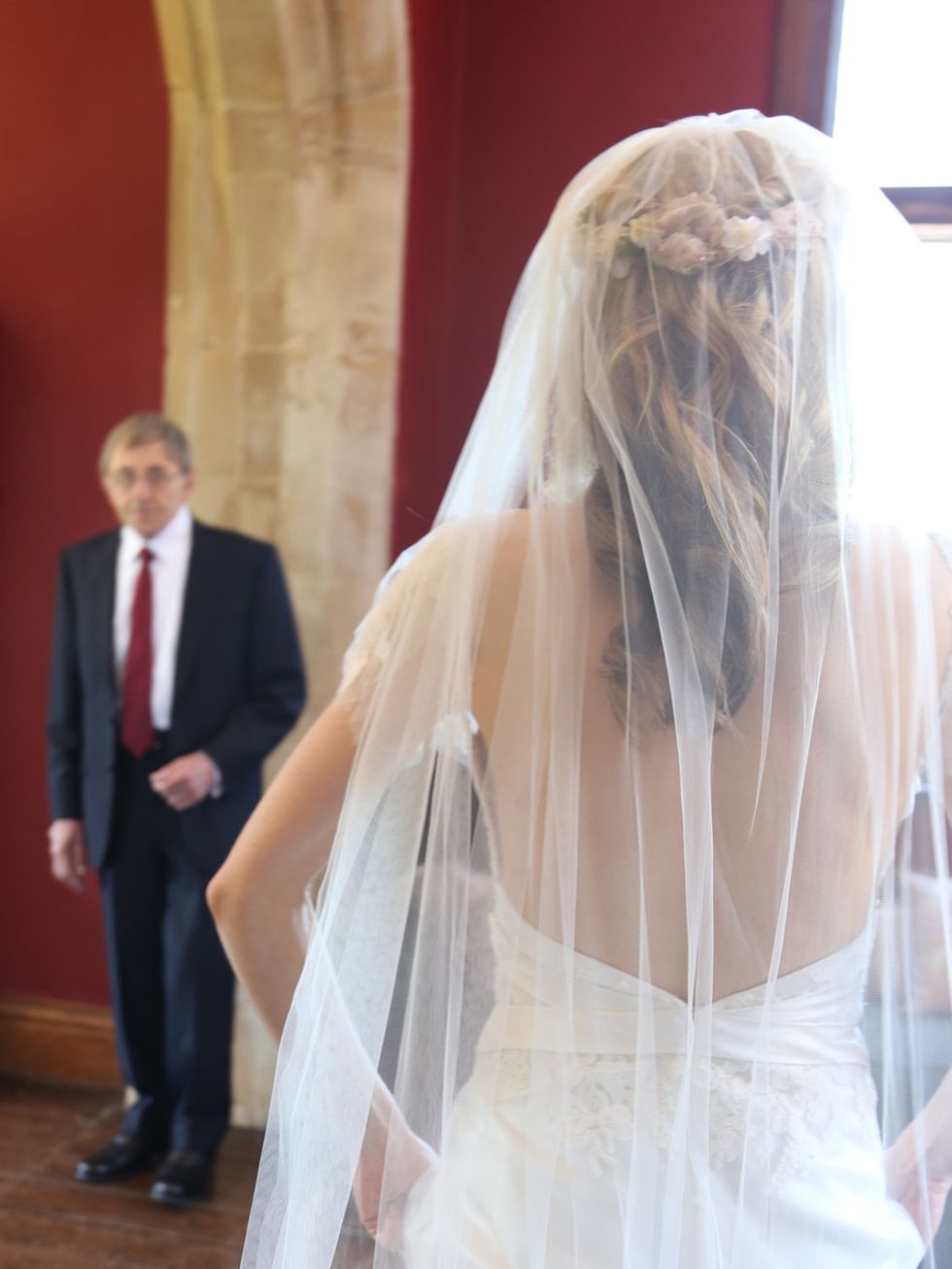 <p><strong>The Veil and Garland</strong></p><p>'We were having a church ceremony, so I thought it wise to temper the raciness of my gowns low-cut back with a demure veil. I chose a single layer, full length style, which cascaded to the floor in perfect s