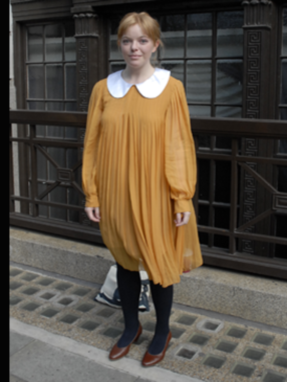 <p>Jennifer found her pleated mustard dress at Spitalfields market and it's Chloe - we are so jealous. Paired with navy opaques and simple brown leather court shoes her enviable dress takes centre stage.</p>