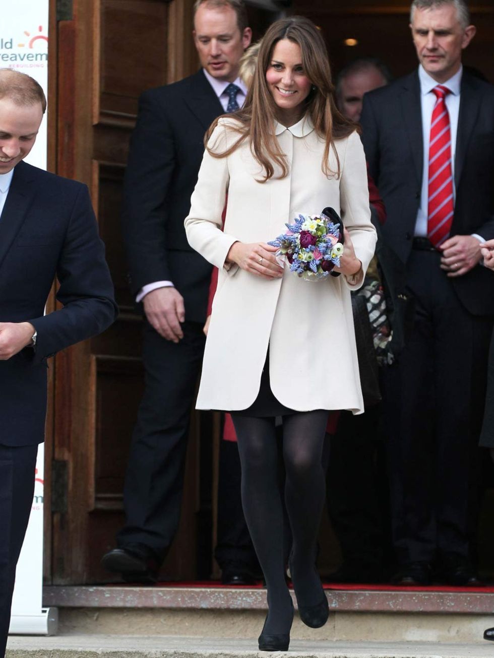<p>Kate Middleton wearing a white coat visits the offices of Child Bereavement UK, March 2013.</p>