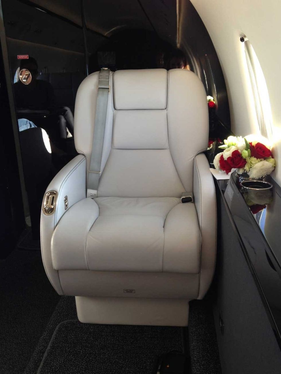 <p>White leather chairs on swivel settings - the seats on offer when travelling by private jet. The red rose posies were a nice touch too. Easyjet, eat your heart out.</p>