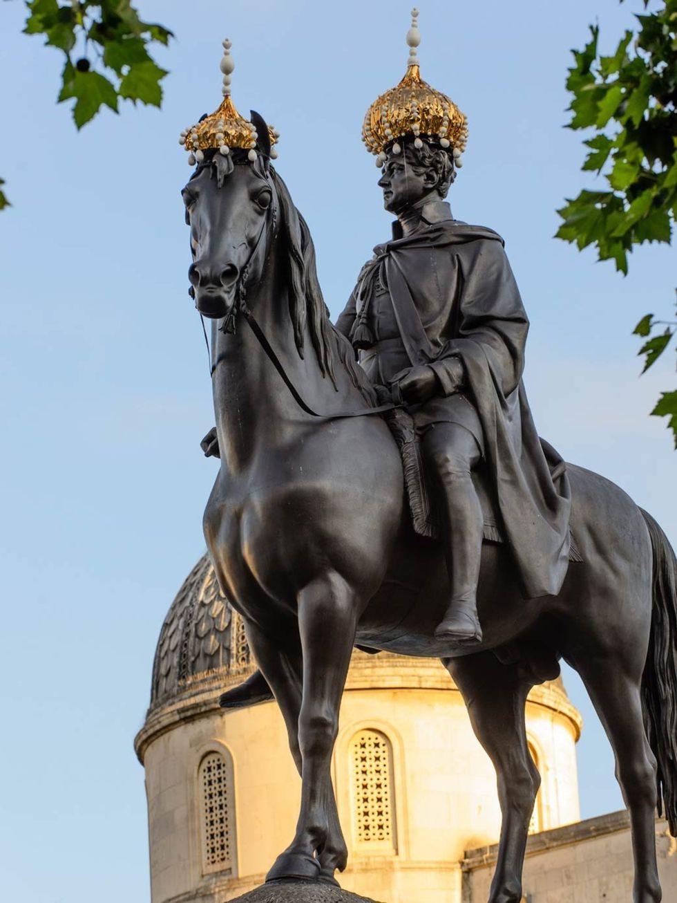 <p>Stephen Jones's crowns on the mounted sculpture of King George IV in Trafalgar Square</p>