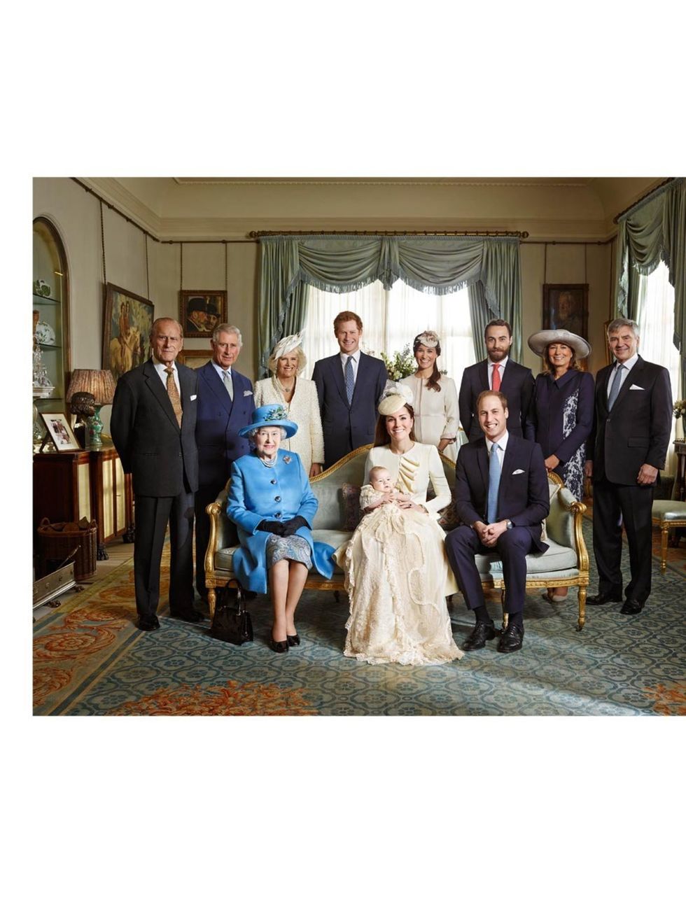 <p>The Royal family with Prince George wearing an outfit made of delicate Honiton lace and white satin by Angela Kelly, an exact replica of the one worn before him by every baby born to the British Royal family since 1841. The Duchess is wearing Alexander