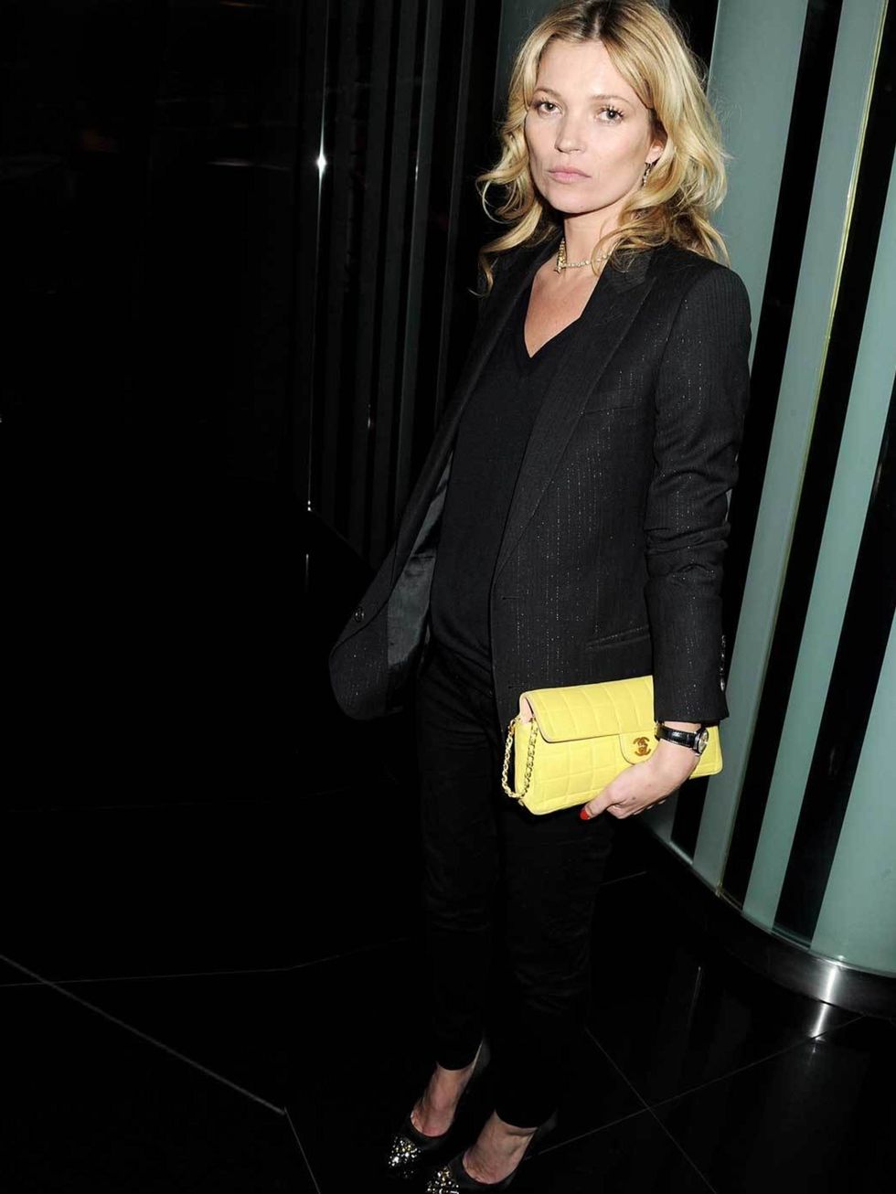 <p><a href="http://www.elleuk.com/star-style/celebrity-style-files/kate-moss">Kate Moss</a> adds a splash of colour to her black ensemble with a classic yellow <a href="http://www.elleuk.com/catwalk/designer-a-z/chanel/autumn-winter-2012/review">Chanel</a