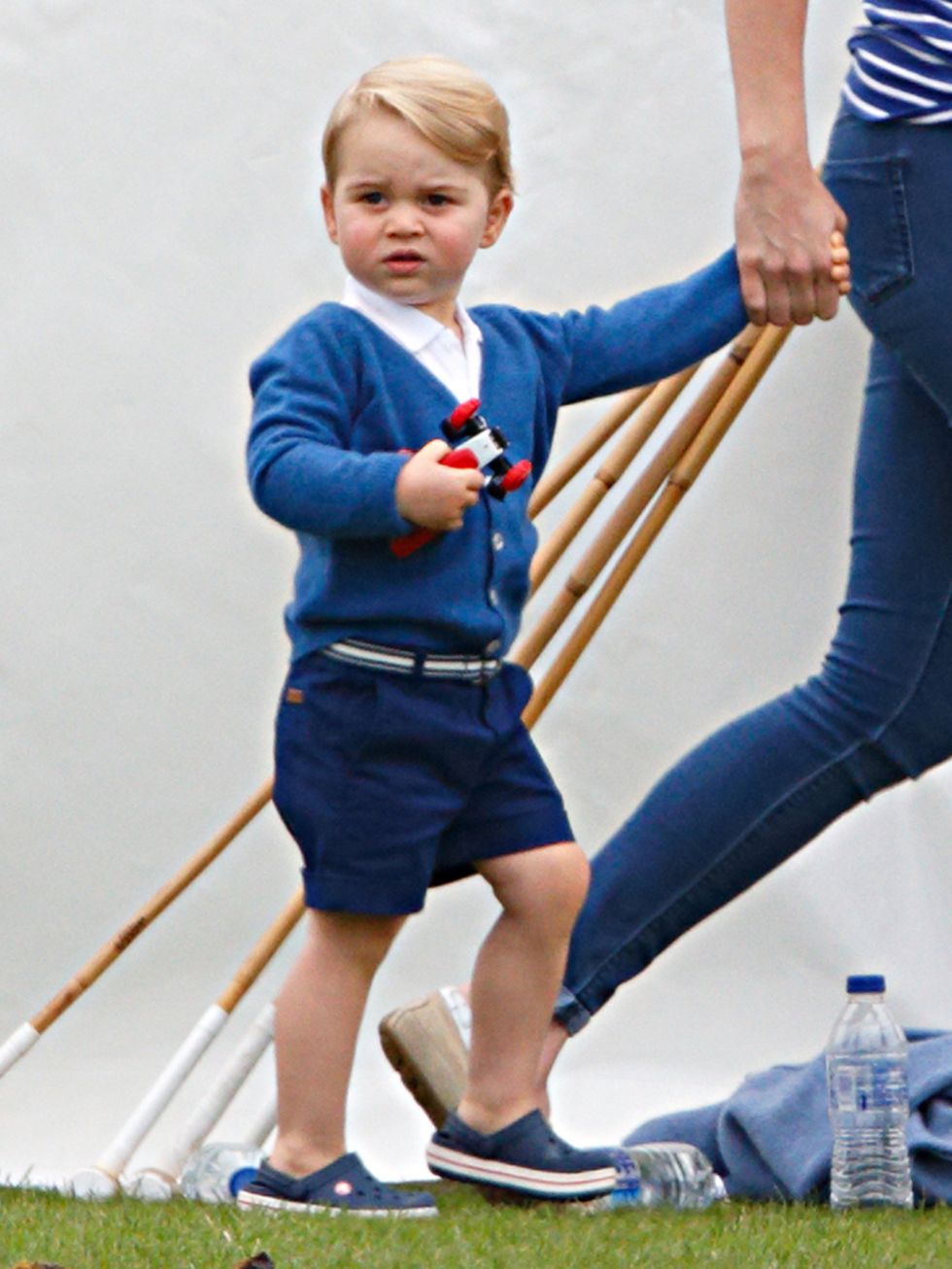 <p>Prince George, wearing a blue cardigan with a star on the back, watches dad William play at the Gigaset charity polo match in Tetbury, June 2015.</p>