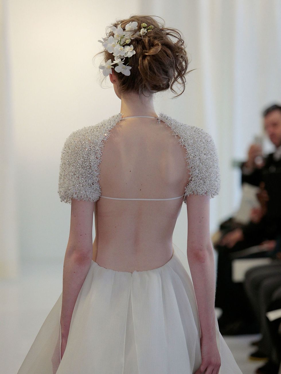This messy up-do with white flowers blossoming from one side was pure romance at Angel Sanchez