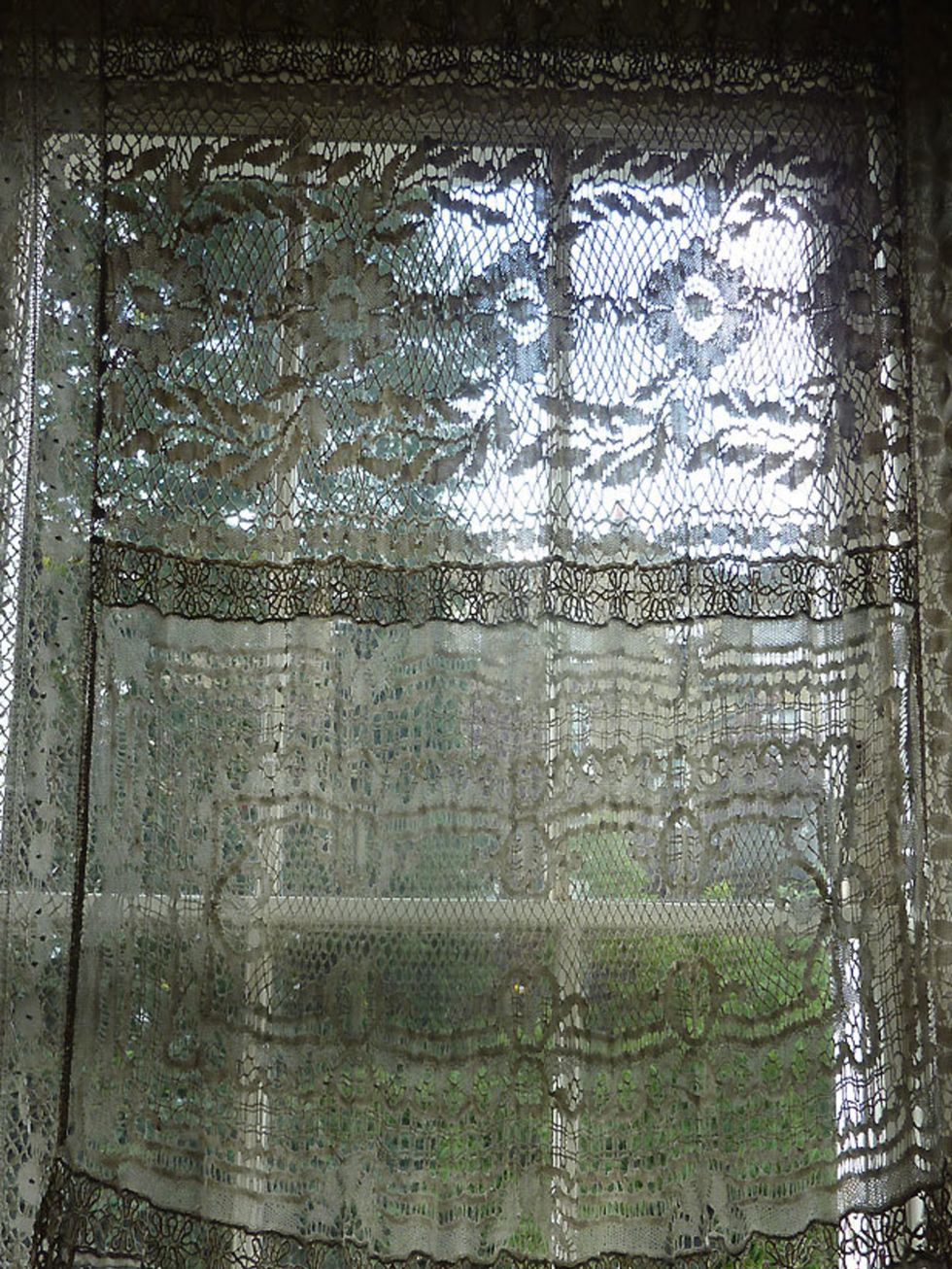 <p>Curtains in designers Inacio Ribeiro &amp; Suzanne Clements windows bought from a flea market in Paris inspired lace in the Spring/Summer 2011 collection</p>